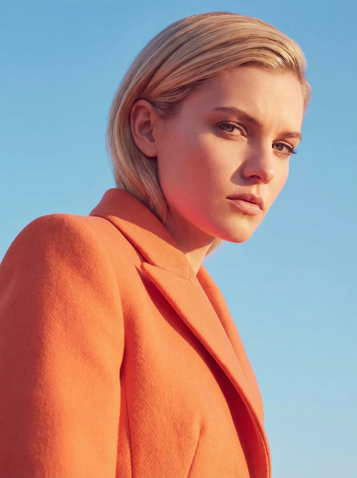 Blonde in Orange Coat – AI photo prompt example